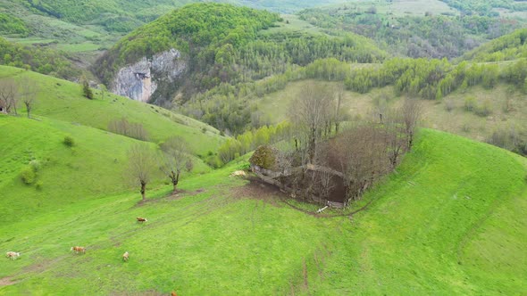 Aerial View of Spring Countryside Landscape with Wooden Houses and Limestone Cliffs