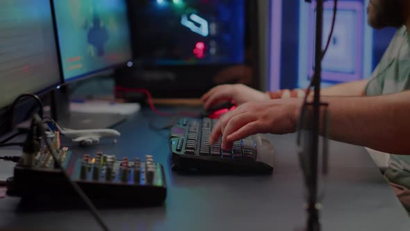 Close Up of Streamer Typing at RGB Keyboard Playing Space Shooter Videogame