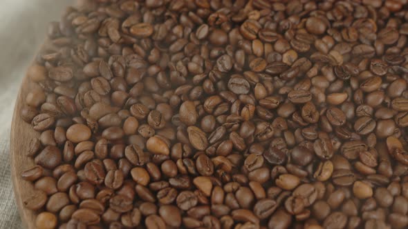 Lots of Coffee Beans on Wooden Board with Dissipating Steam