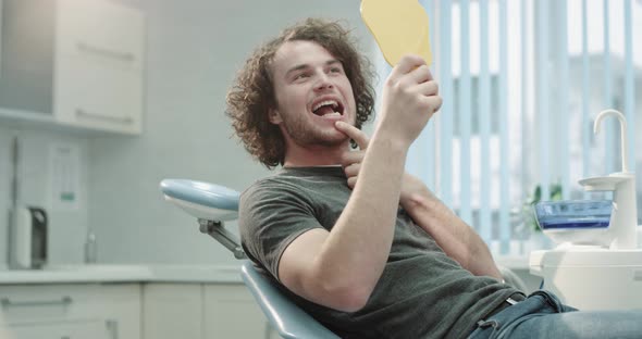 Curly Hair Man in Dental Clinic Room Sitting on