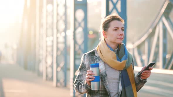 Portrait of a Young Caucasian Businesswoman in a Coat Walking Around the City on a Frosty Morning