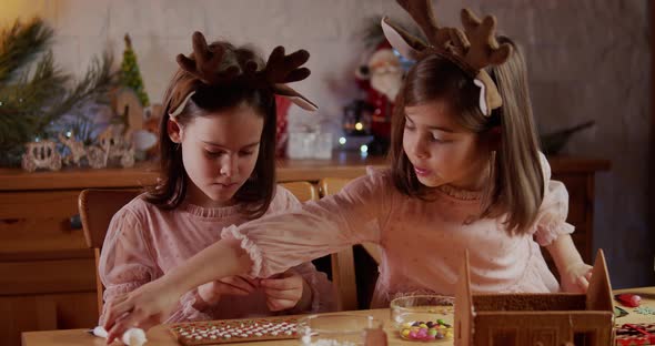 Two Cute Sisters Build Decorate Christmas Gingerbread House