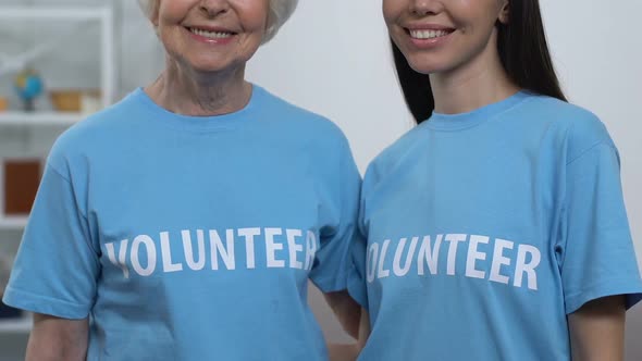 Aged and Young Women Volunteers Looking to Cam and Smiling Charity Organization