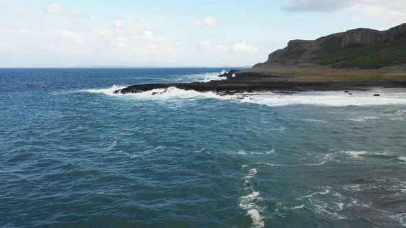 Aerial view of rocky coastline and waves