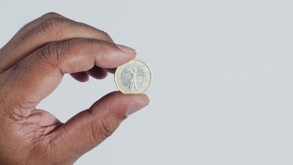 Hand Holding Euro Coin Back 