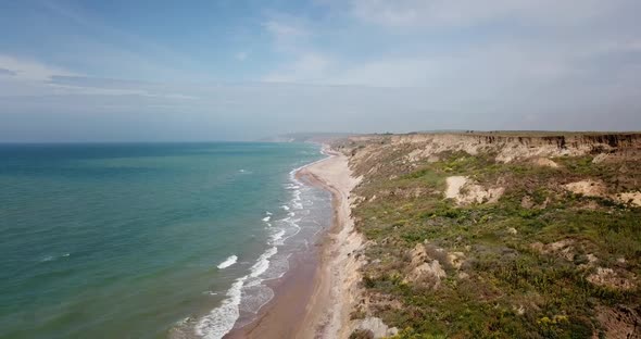 Tropical Beach Video, Aerial Bird Eye View of Blue Foaming Ocean Waves Crushing Against the Coast