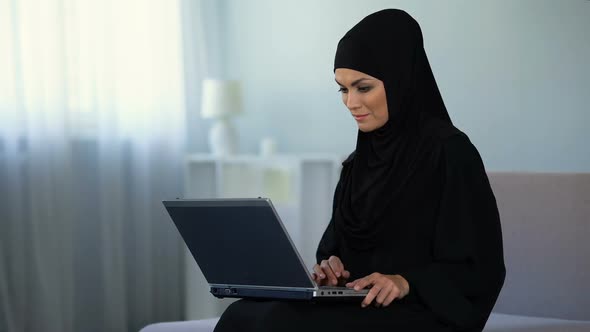 Muslim Woman Scrolling Laptop, Working at Home, Online Education, Technology