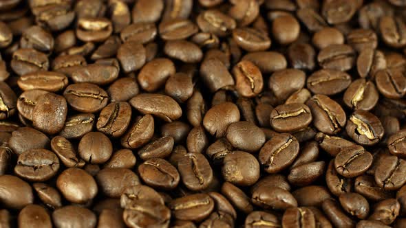 Rotation close-up of coffee beans 360. Golden selected aromatic beans rotates