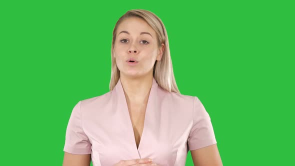 Young woman talking to the camera on a Green Screen, Chroma Key.