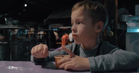 Child enjoying ice-cream in cafe