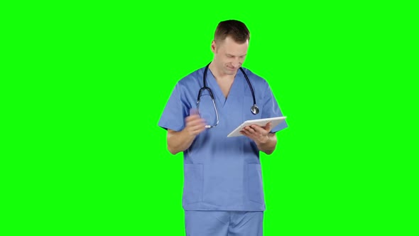 Doctor Uses a Tablet and Shows Thumb Down. Green Screen