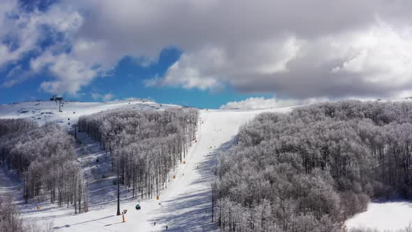 Aerial view at the ski slopes on a sunny winter day