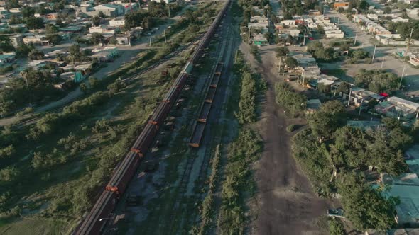 Aerial Of A Freight Train Passing Through Mexican northern Countryside