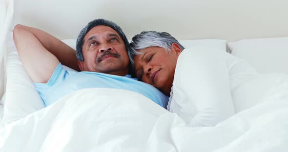 Senior couple relaxing in bedroom 4k