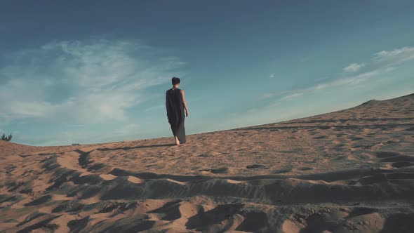 Young Woman Walking in Desert Landscape