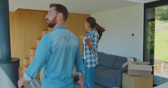 Couple Carrying Boxes Into New Home On Moving Day.