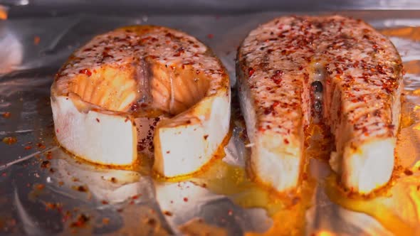 Salmon grilled in the oven close-up. Salmon steak with spices grilling in the oven slow motion