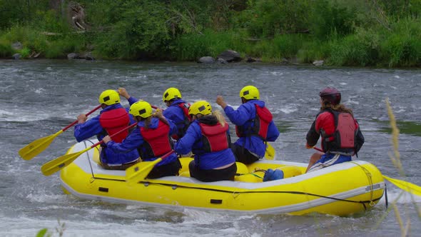 Group of people white water rafting