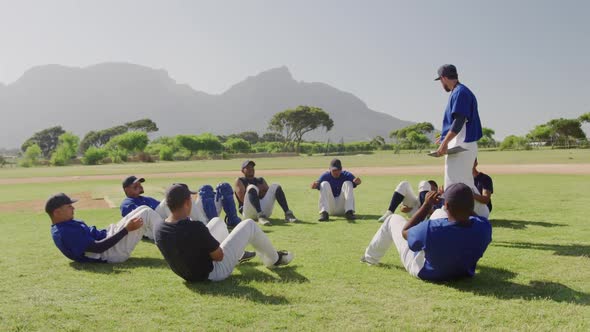 Baseball players doing sit ups at a playing field