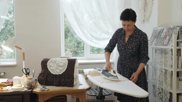 Woman ironing in the studio