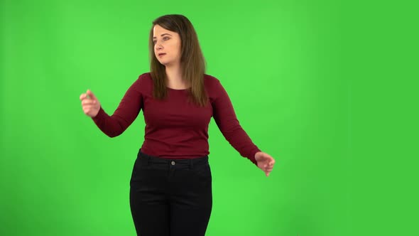 Angry Girl Is Waving Her Hands in Indignation, Shrugs. Green Screen