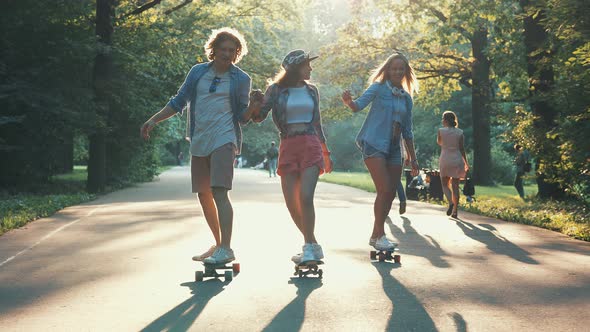Young people skateboarding in summer 