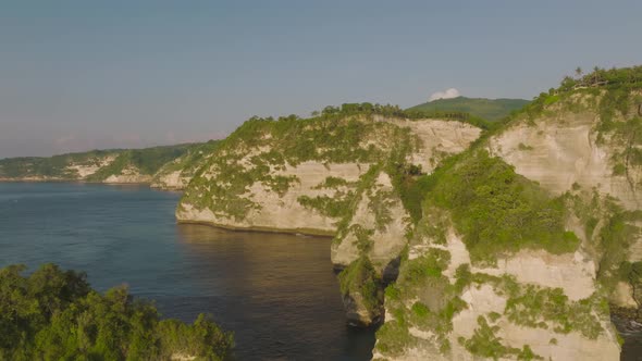 Thousand island viewpoint illuminated by morning sunlight, Nusa Penida, tropical cliffs