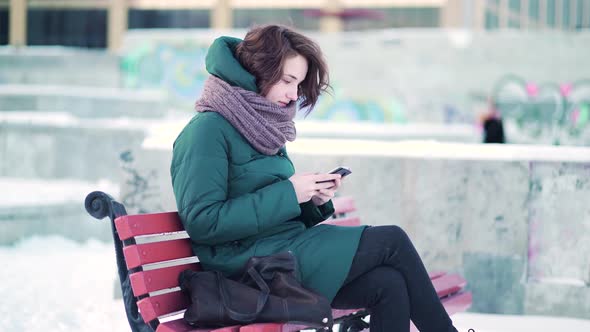 Lovely Brunette Browsing On Her Mobile Phone