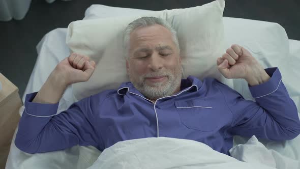 Elder Basking in His Bed Rejoicing at New Orthopedic Mattress, Comfortable Sleep