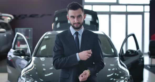 Portrait of Young Positive Caucasian Man Throwing Up Car Keys and Smiling at Camera. Successful