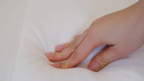 Woman is Choosing New Mattress for Good Sleeping