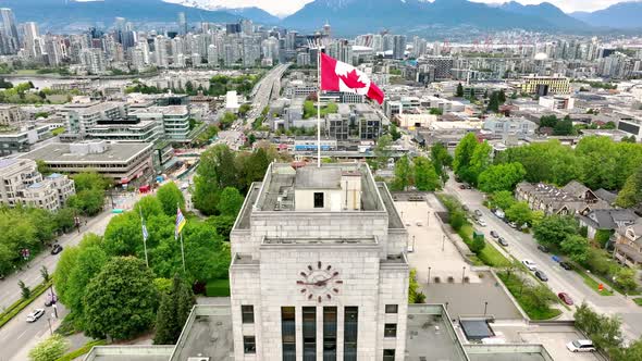 Drone Rises Above Vancouver City Hall With Waving Flag In Vancouver, British Columbia, Canada. Aeria