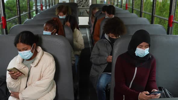 Masked Multiracial Students Riding School Bus