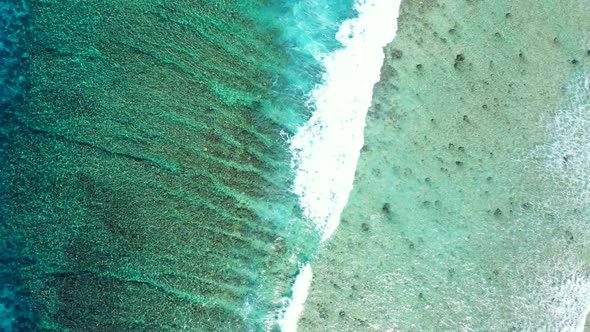 Aerial flying over landscape of tranquil tourist beach holiday by clear ocean and clean sand backgro