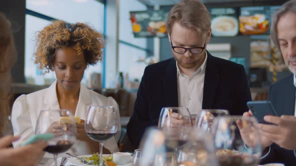 Diverse People with Mobile Phone Addiction in Restaurant Surfing Internet