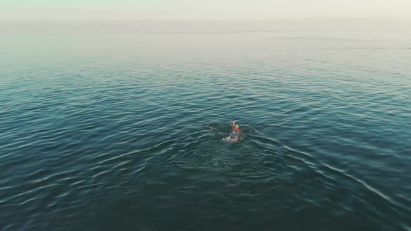 Aerial View of Young Woman Swimming in the Transparent Turquoise Sea Water