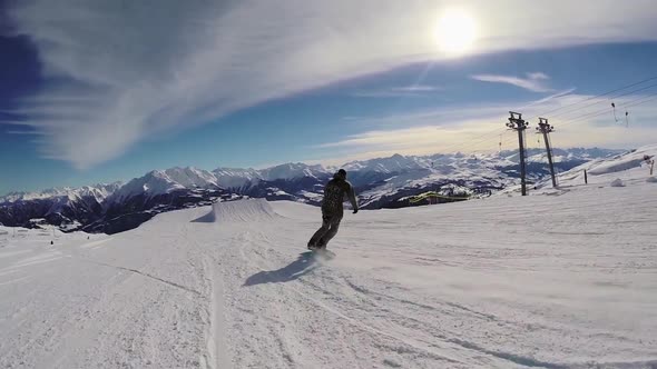 A young man snow boarding.