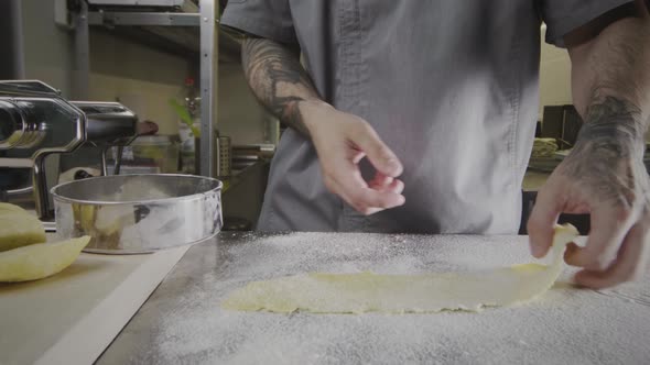 Working with pastry dough in a commercial kitchen.