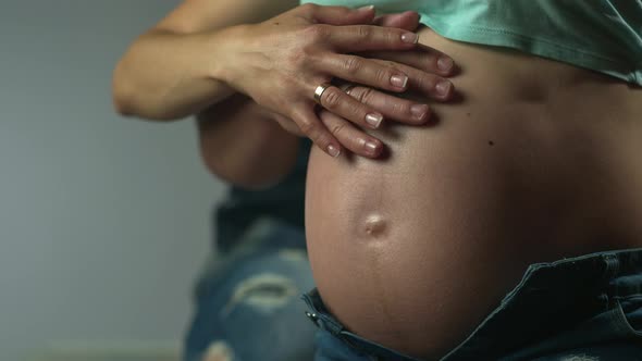 Mom and Dad Hands on Pregnant Tummy