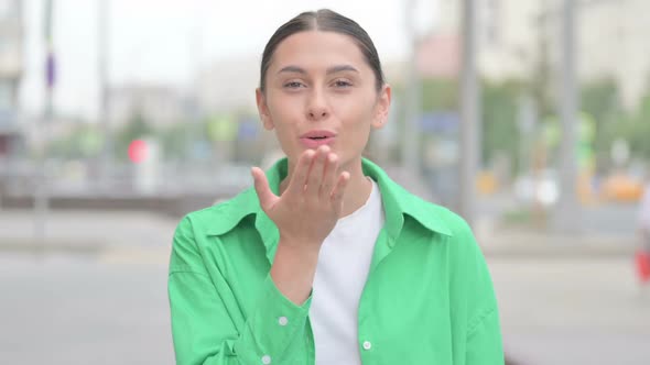 Flying Kiss By Loving Hispanic Woman Outdoor