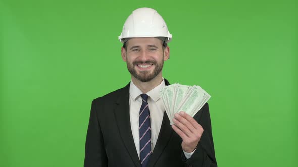 Ambitious Young Engineer with Money Against Chroma Key