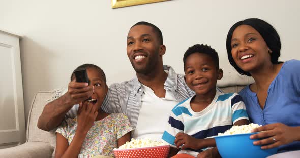 Family watching television in living room 4k