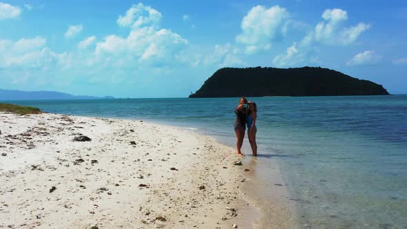 Beautiful ladies tan on beautiful island beach lifestyle by turquoise sea and white sandy background