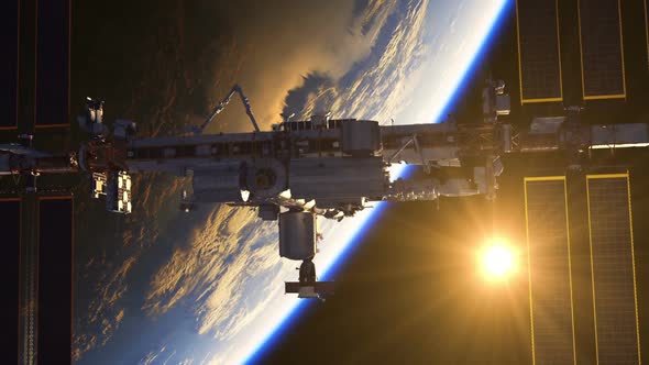 Flight Of International Space Station On The Background Of Earth And Rising Sun alt