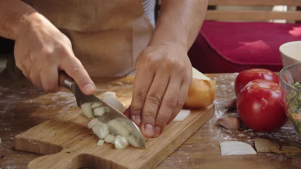 Men's Hands Cutting Onion on Wooden Board. Chef with Knife Cut Vegetables, Mexican or Latin American