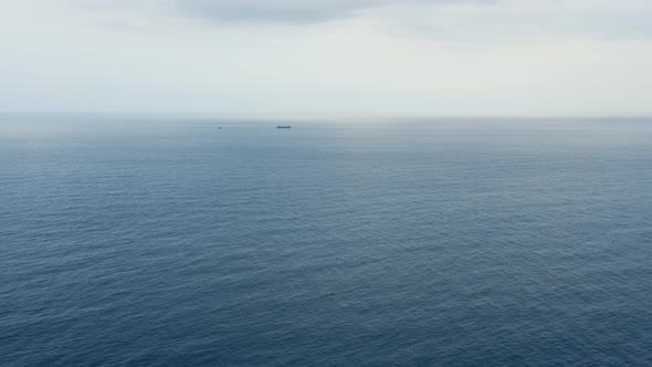 Oil tanker with tugboat on the horizon