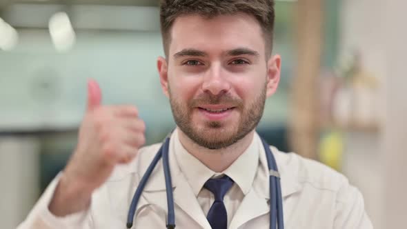 Positive Young Doctor Showing Thumbs Up Sign