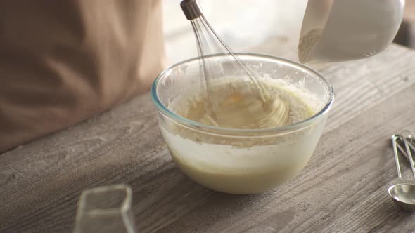 The Hostess Cook Mixes Flour With Eggs With A Whisk.