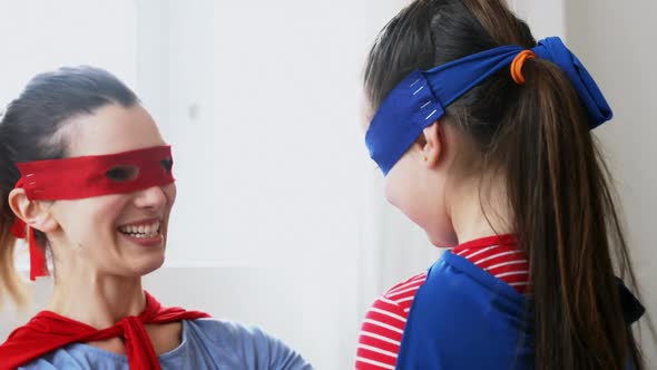 Mother and daughter pretending to be superhero 