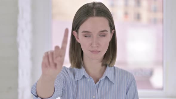 Portrait of Young Woman Saying No with Finger Sign
